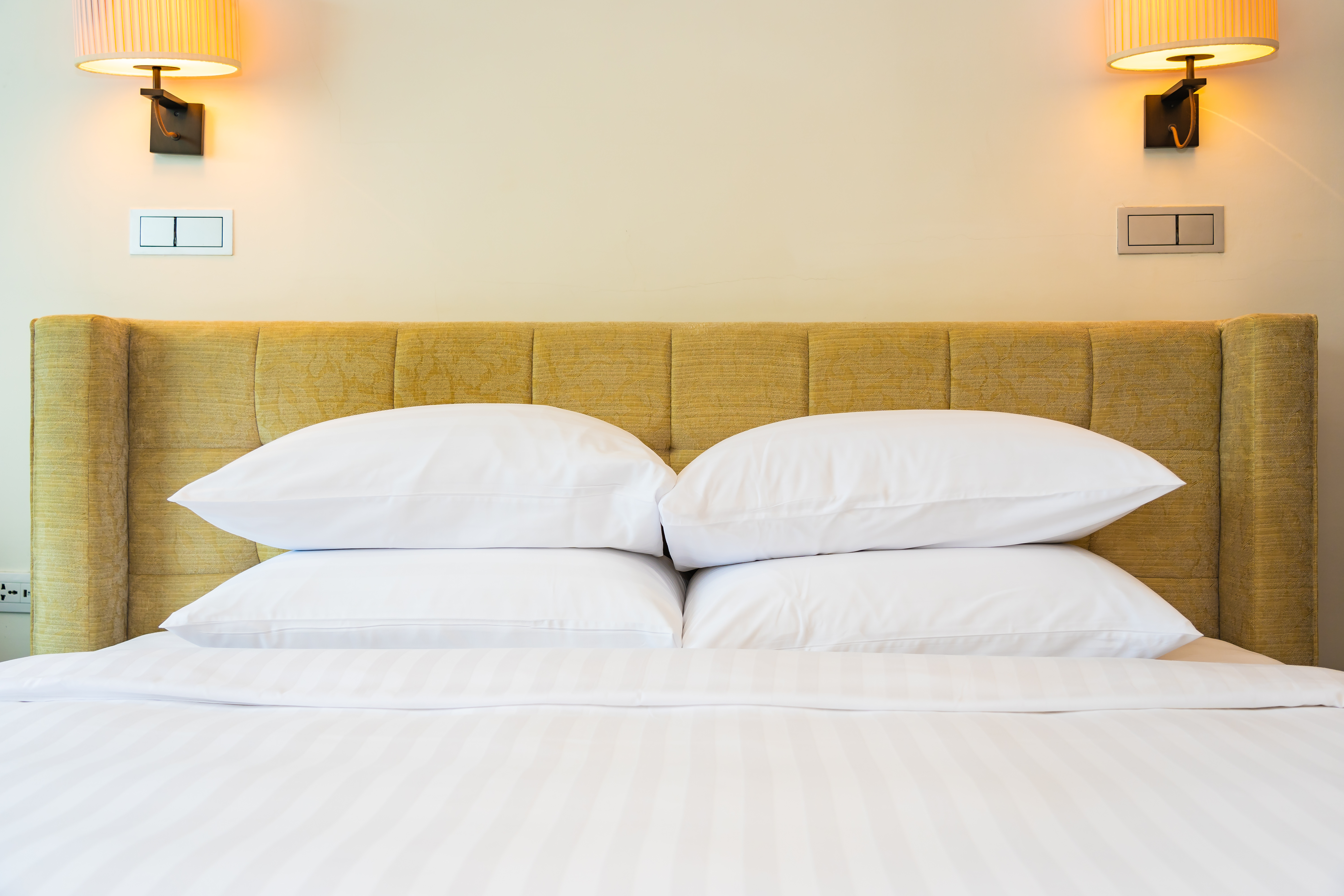 White pillow and blanket with light lamp decoration interior of bedroom